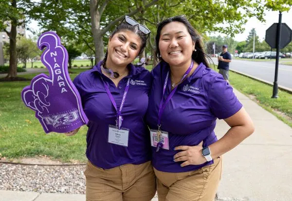 Two students in NU gear