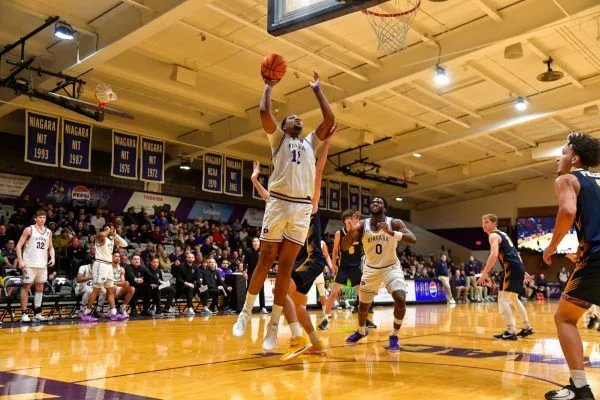 niagara university basketball player making a layup