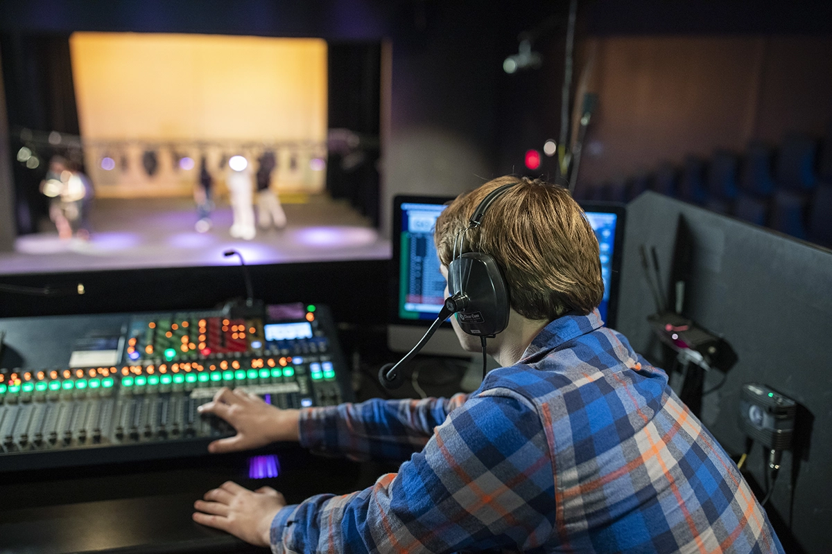 nu theatre student working on stage sound